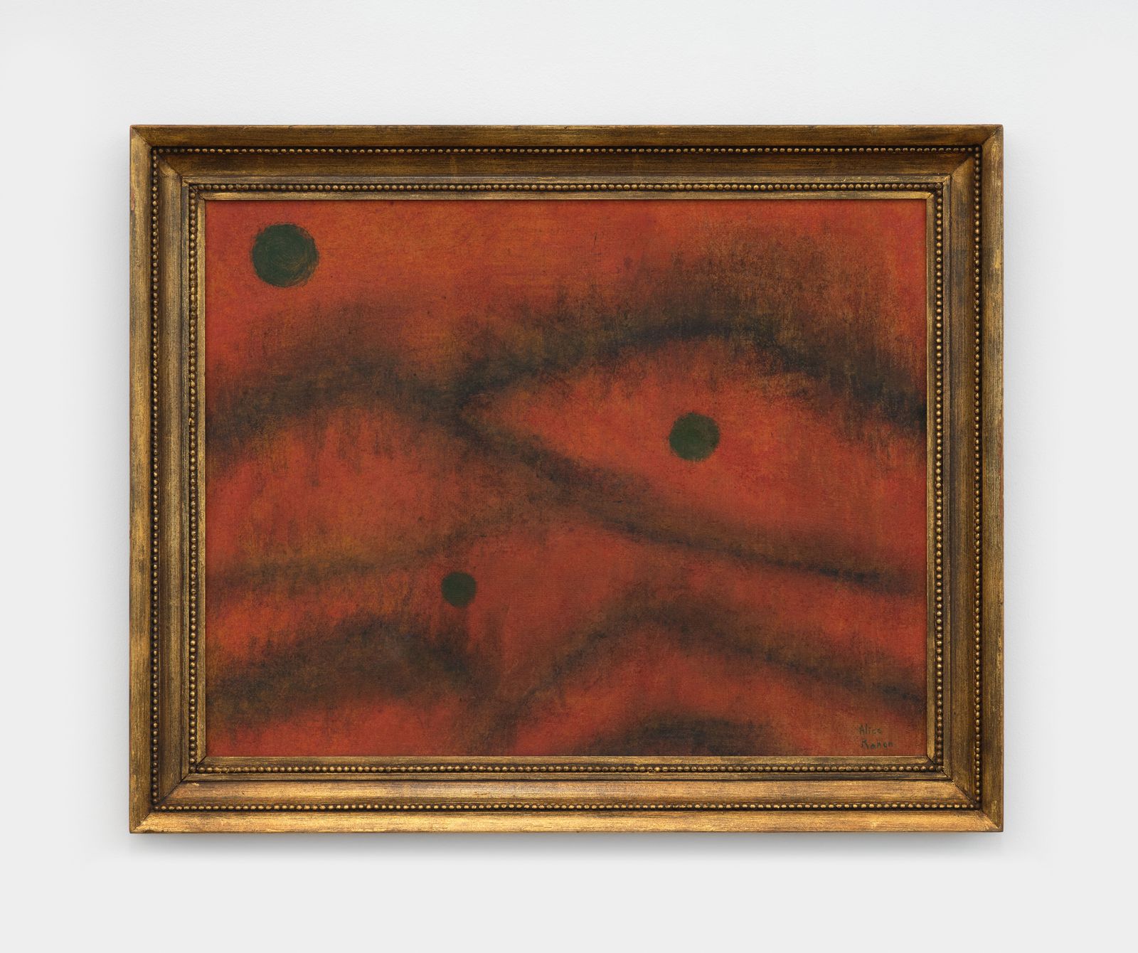 Alice Rahon painting in deep red with dark ridges and three small black circles, in a gilded frame