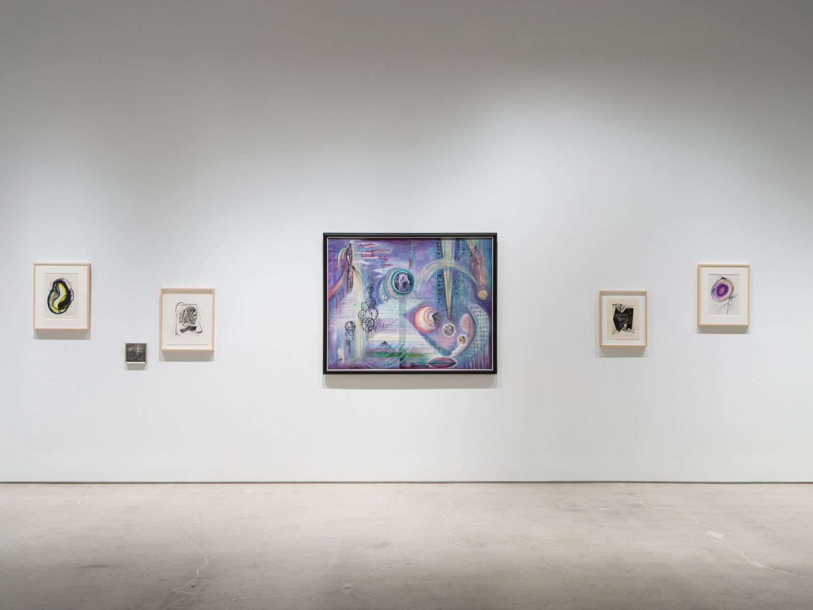 Installation view of Dictation from the Other Side at Karma, with small framed works around Juanita Guccione’s Syzygy